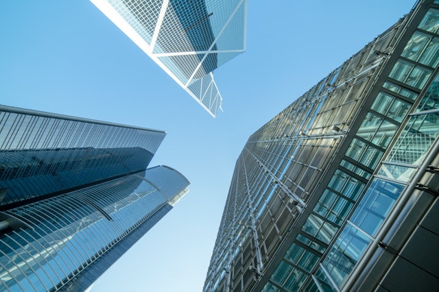 low-angle-photography-of-buildings-under-blue-and-white-sky-998499